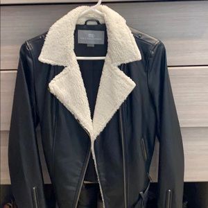 Black leather jacket with faux fur collar.